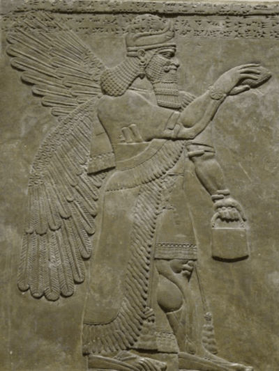 Ancient Assyrian stone relief of a winged apkallu figure holding a bucket and cone