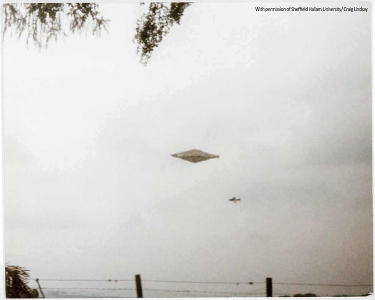 Calvine photograph showing a diamond-shaped object and a distant military jet in a daytime sky